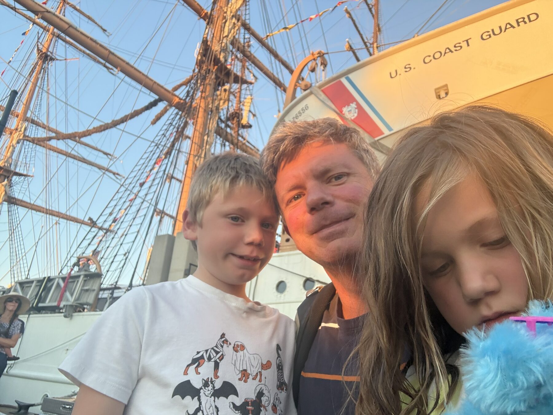 Teddy, Dad and sister in front of the tall ships in Norfolk